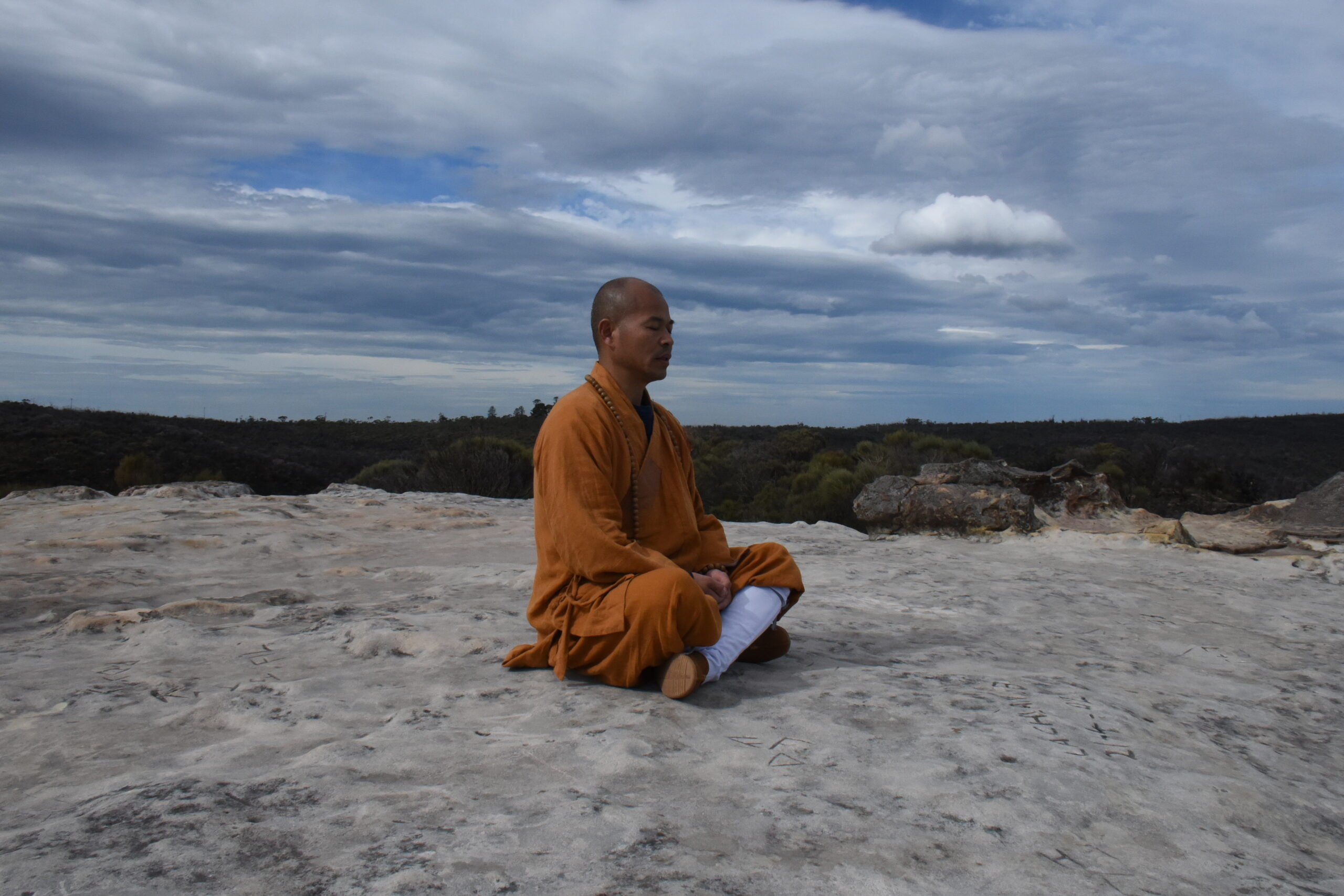 Shaolin Grandmaster Shi Deyang meditating in the Blue Mountains, Australia