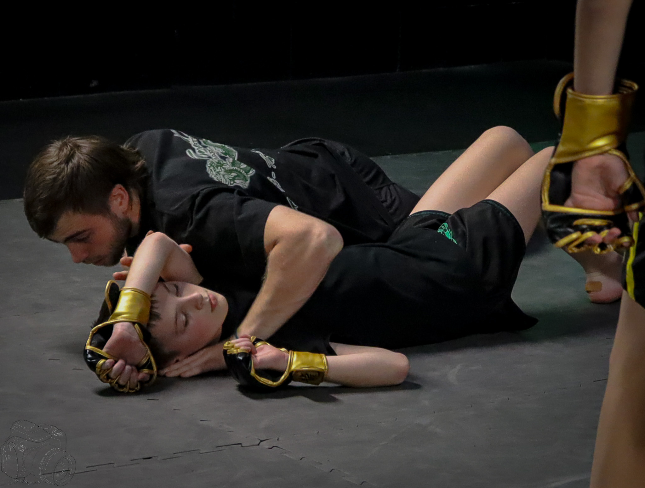 Kids practicing MMA with protective gear in a safe environment at Emerald Dragon Martial Arts.